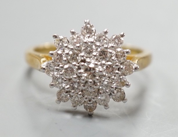 A modern 18ct gold and diamond cluster set flower head ring, size R/S, gross weight 5.5. grams.